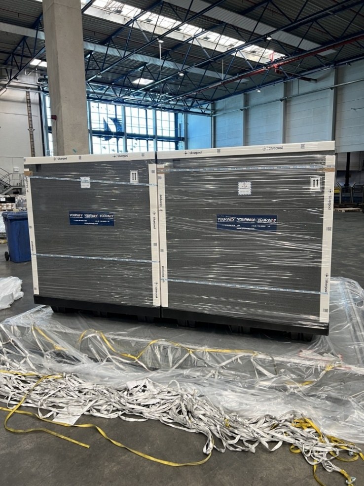 Multiple large temperature-controlled pallet shippers prepared for transport
